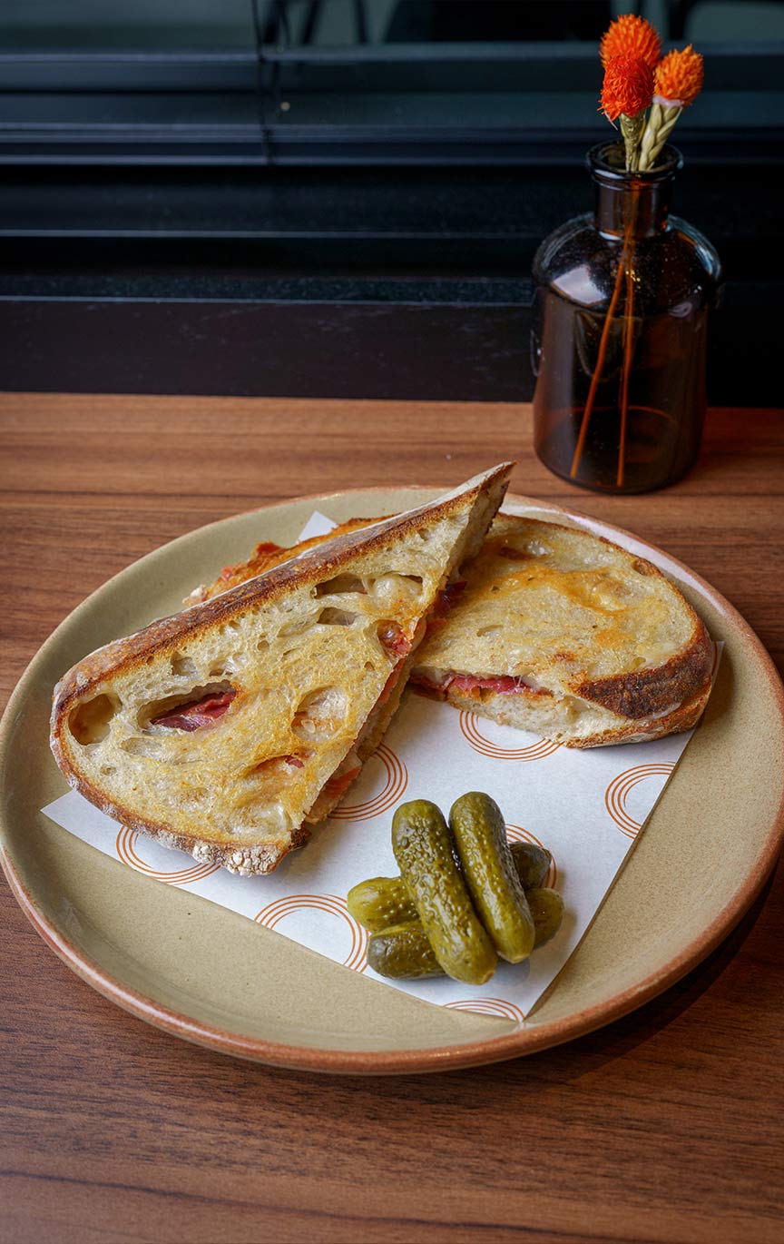 Atomeca Bar Toasted Sandwich with Gherkins on a branded Atomeca napkin